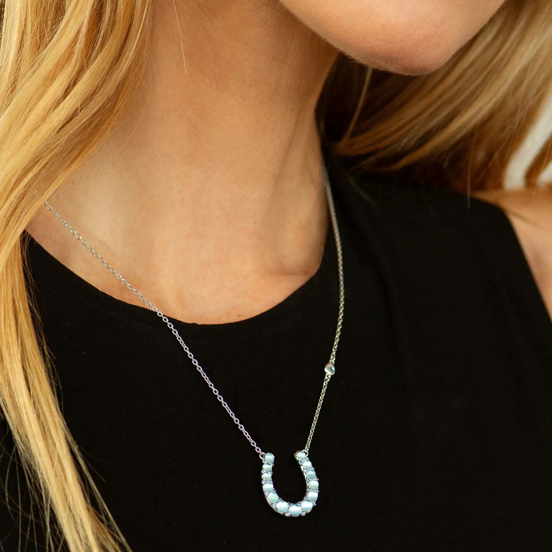 The Horseshoe Necklace with Blue Topaz Over Mother of Pearl